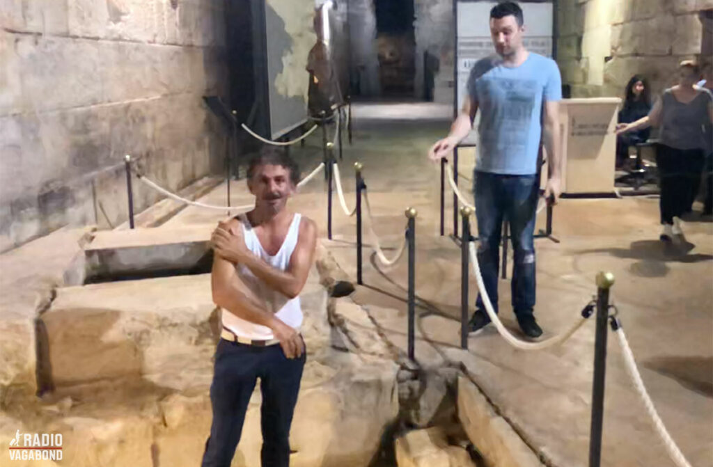 One of the locals washes his face in the wishing well and goes berserk when the guard (on the right) tells him to leave.