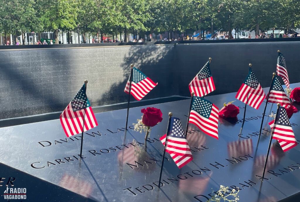 9/11 Memorial with many flags on the edge on one of the pools.
