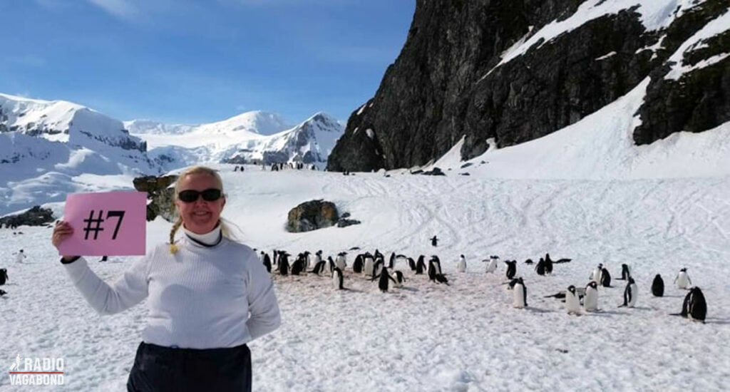 Cynthia in Antarctica surrounded by penguins