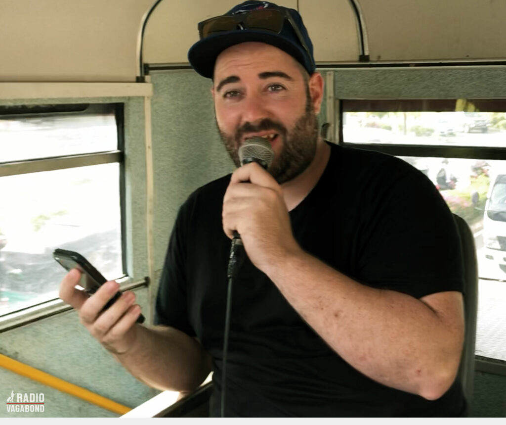 Travel Dave takes control of the microphone on a bus in Sri Lanka